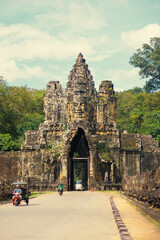 Naklejka premium Angkor Thom Gate With Bayon Face Tower And Traffic, Siem Reap, Cambodia