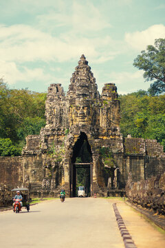 Angkor Thom Gate With Bayon Face Tower And Traffic, Siem Reap, Cambodia