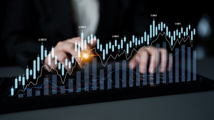 Close-up of hands interacting with digital graphs on a touchscreen, showcasing financial data analysis, market trends, and investment strategies in a modern workspace. Scalp