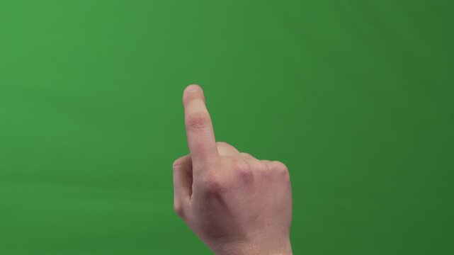 Close up of human hand with raised index finger performing scrolling gesture as if browsing a virtual page or touchscreen. Isolated on green chroma key background for interface compositing.