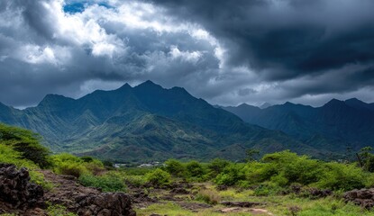 Jagged green mountains under a dramatic stormy sky.