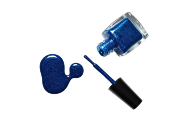 Deep sapphire blue nail polish spilled into glossy and glittery drops, with an open square bottle and brush on a bright white background, flat lay, macro. Concept for cosmetic advertising