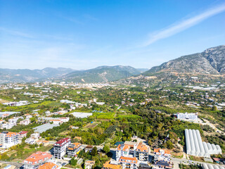 High-Angle Aerial View of the Fertile Valley Floor Near Alanya, Showing a Mix of Residential Development and Agricultural Greenhouses
