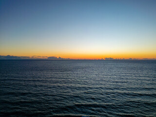 Wide Aerial Shot of the Mediterranean Sea Horizon at Sunset or Sunrise with a Clear Sky Gradient