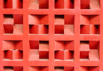 Terracotta red rooster wall texture with a geometric pattern. This ventilation block background...