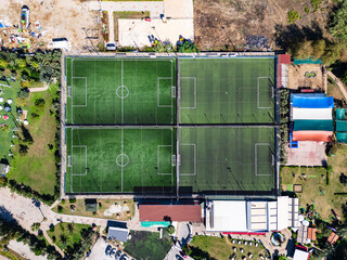 High-Angle Drone View of Four Adjacent Green Artificial Turf Soccer Fields in a Sports Complex © Projecturk