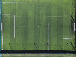 Top-Down Aerial View of a Single Green Artificial Turf Soccer Field, Highlighting Goal Boxes and White Lines © Projecturk