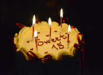 Sweet Fifteen Birthday Cake with Candles and Cream Decoration