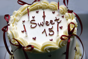 Sweet Fifteen Birthday Cake with Candles and Cream Decoration