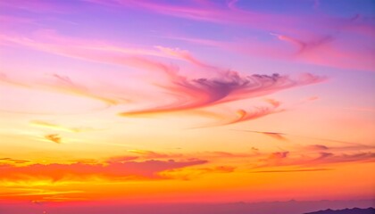 A beautiful dramatic sunset over the sea features a vibrant orange and blue cloudscape with bright sunlight glowing during a summer evening dusk landscape