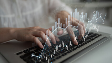 A person typing on a laptop with overlaid financial graphs and charts, conveying data analysis and technology in a contemporary office environment. Scalp