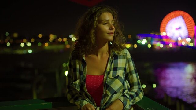 A girl enjoying the Santa Monica Pier night lights