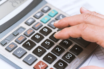 Close up of hand with calculator on the table. Business concept.