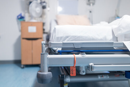 Shallow focus of the edge of a hospital bed seen in a typical NHS hospital in Britain. The room is a private room off the main ward.