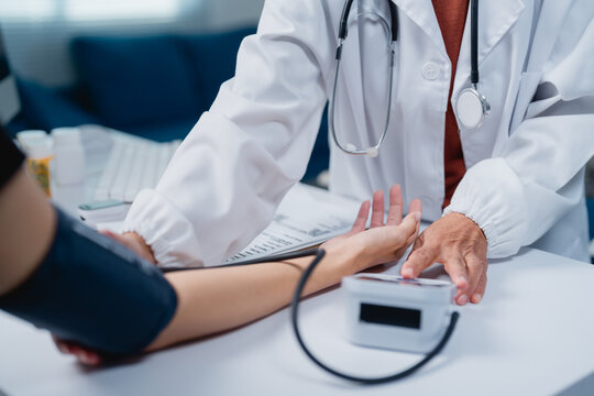 Doctor checking patient's blood pressure during medical consultation