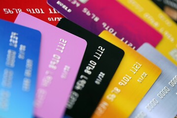 Many credit or debit cards with fictional specimen numbers. Big amount of banking plastic cards of various colors. Financial concept of business and e-commerce