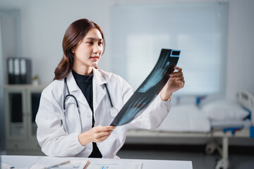 Female doctor analyzing x-ray for diagnosis and treatment