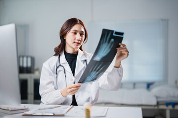 Female doctor examining x-ray with hand scan for diagnosis