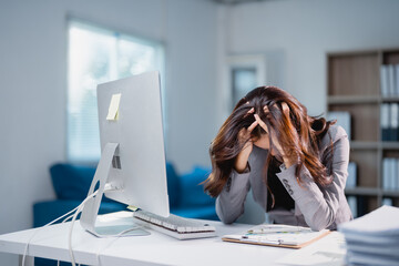 Businesswoman experiencing burnout and stress from overwork in office