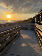 Obraz premium Miramar Beach, Florida public beach access with golden sun setting over the Gulf of Mexico 