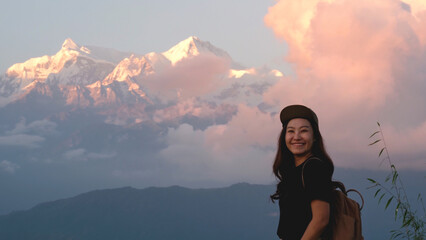 Portrait image of a woman traveler with Annapurna mountain range in Pokhara, Nepal