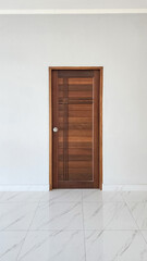 Minimalist wooden door with geometric panel design on a white interior wall, featuring clean lines and a modern aesthetic, representing contemporary home design and architectural simplicity.