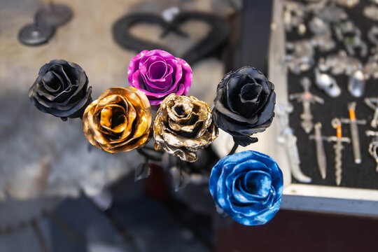 Forged roses close-up. A bouquet of beautiful multi-colored roses made of metal. A young craftsman forged wonderful roses. - Powered by Adobe