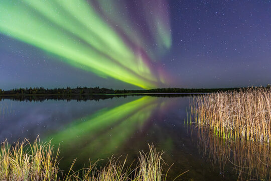 Yellowknife, Canada - September 23, 2025: North lights with a lake in the background