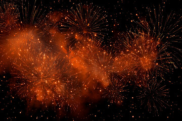 vibrant orange fireworks explode against a dark night sky