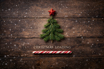 Christmas tree of pine leaves with loading in candy cane.