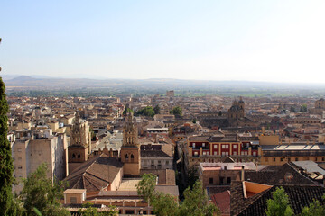 Obraz premium Hilltop view of Granada with church towers, cathedral, basilicas, and historic skyline, photographed in July 2024.