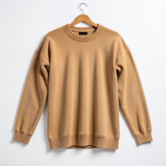 Tan sweater hanging on a wooden hanger against a clean white backdrop showcase
