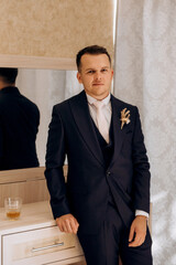 portrait of the groom of a man in the morning before the wedding