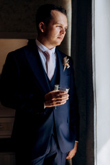 portrait of the groom of a man in the morning before the wedding