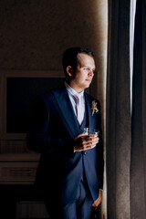 portrait of the groom of a man in the morning before the wedding