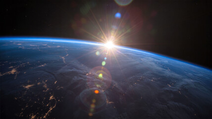 Earth from space with sun rising over horizon at dawn