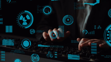 This image depicts hands typing on a keyboard while futuristic data visualization overlays the scene, highlighting technology, analytics, and innovation in a dark setting. Xenic