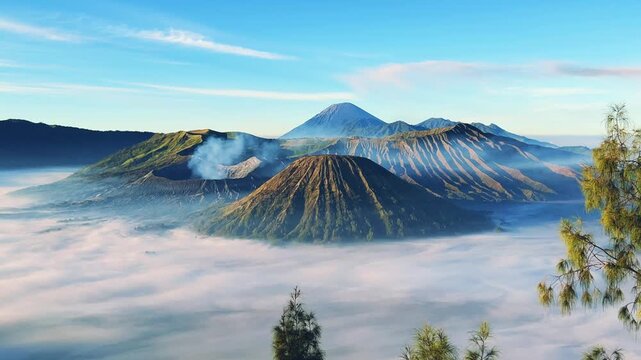 Eruption of the Bromo volcano during sunrise in the Bromo-Tengger-Semeru National Park, East Java, Indonesia. The Tengger volcanic caldera is in cloud and fog. Dawn. 4К