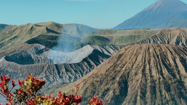 Eruption of the Bromo volcano during sunrise in the Bromo-Tengger-Semeru National Park, East Java, Indonesia. The Tengger volcanic caldera is in cloud and fog. Dawn. 4К