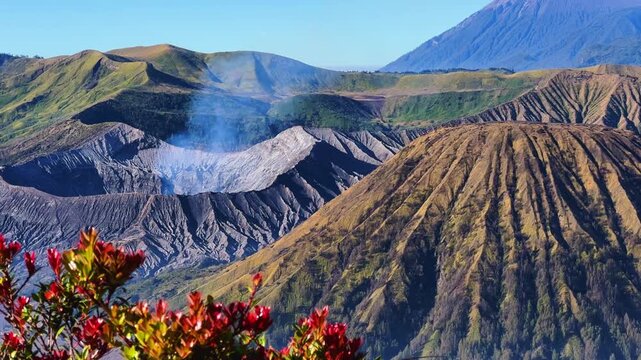 Eruption of the Bromo volcano during sunrise in the Bromo-Tengger-Semeru National Park, East Java, Indonesia. The Tengger volcanic caldera is in cloud and fog. Dawn. 4К