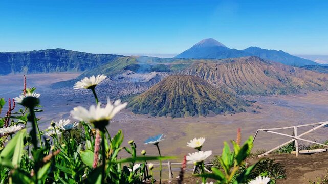 Eruption of the Bromo volcano during sunrise in the Bromo-Tengger-Semeru National Park, East Java, Indonesia. The Tengger volcanic caldera is in cloud and fog. Dawn. 4К