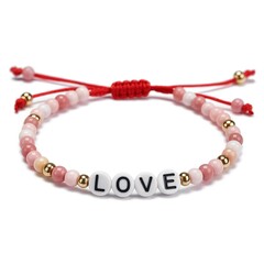 Fototapeta premium Valentines love bead bracelet jewelry trendy gift with red string on white seamless background, artistic