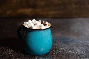 mug of hot chocolate with marshmallows on dark background, horizontal