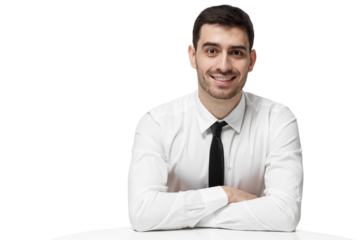 Smiling businessman sitting at white table with arms crossed looking at the camera