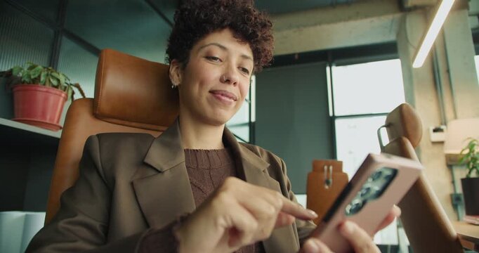 Female professional examines mobile financial interface carefully