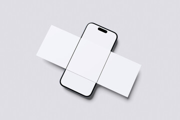 Smartphone mockup with blank screen and folded paper cards on white background, modern mobile device with empty stationery layout, clean branding composition representing marketing and presentation
