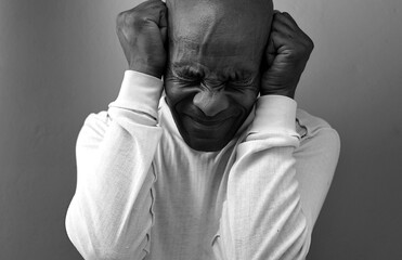 deafness suffering from deafness and hearing loss Senior man cupping his ear having difficulty hearing on gray background with people stock photo stock image