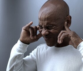 deafness suffering from deafness and hearing loss Senior man cupping his ear having difficulty hearing on gray background with people stock photo stock image