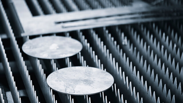 Metal round parts cut by plasma laser machine lie on tool table at metalworking plant industrial concept background