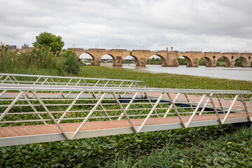 pier on the Guadiana river with a view to bridge of Palmas in Badajoz city, Extremadura, Spain